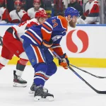 Mar 6, 2026; Edmonton, Alberta, CAN; Edmonton Oilers defensemen Mattias Ekholm (14) looks to get a shot away in front of Carolina Hurricanes forward Jordan Martinook (48) during the first period at Rogers Place. Mandatory Credit: Perry Nelson-Imagn Images