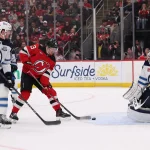 Jan 27, 2026; Newark, New Jersey, USA; New Jersey Devils left wing Jesper Bratt (63) scores a goal on Winnipeg Jets goaltender Connor Hellebuyck (37) during the second period at Prudential Center. Mandatory Credit: Ed Mulholland-Imagn Images