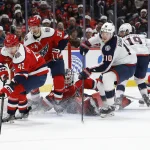 Dec 7, 2025; Washington, District of Columbia, USA; Washington Capitals defenseman Martin FehŽrv‡ry (42) reaches for a loose b=puck in front of Capitals goaltender Logan Thompson (48) and Columbus Blue Jackets left wing Dmitri Voronkov (10) during the second period at Capital One Arena.