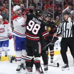 Phillip Danault infuriates Connor Bedard and catches Spencer Knight in mask with skate Oct 23, 2026; Chicago, Illinois, USA; Montreal Canadiens center Kirby Dach (77) fights with Chicago Blackhawks center Connor Bedard (98) during the second period at United Center. Mandatory Credit: Talia Sprague-Imagn Images