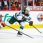 Oct 22, 2026; Calgary, Alberta, CAN; Minnesota Wild defenseman Quinn Hughes (43) passes the puck against the Calgary Flames during the third period at Scotiabank Saddledome.