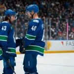 Nov 5, 2025; Vancouver, British Columbia, CAN; Vancouver Canucks defenseman Quinn Hughes (43) talks with forward Elias Pettersson (40) during a stop in play against the Chicago Blackhawks in the second period at Rogers Arena.