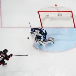 Mar 9, 2025; Raleigh, North Carolina, USA; Winnipeg Jets goaltender Connor Hellebuyck (37) stops the scoring attempt by Carolina Hurricanes center Seth Jarvis (24) during the second period at Lenovo Center.