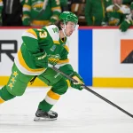 Apr 2, 2026; Saint Paul, Minnesota, USA; Minnesota Wild defensemen Quinn Hughes (43) controls the puck against the Vancouver Canucks during the second period at Grand Casino Arena. Mandatory Credit: Nick Wosika-Imagn Images