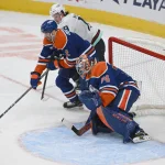Mar 22, 2025; Edmonton, Alberta, CAN; Edmonton Oilers defenceman Evan Bouchard (2) battles with Seattle Kraken left wing Jared McCann (19) in front of Edmonton Oilers goalie Stuart Skinner (74) during the second period at Rogers Place.