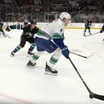 Feb 6, 2025; San Jose, California, USA; Vancouver Canucks right winger Brock Boeser (6) controls the puck ahead of San Jose Sharks defenseman Jack Thompson (26) during the first period at SAP Center at San Jose.