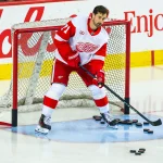 Oct 24, 2026; Calgary, Alberta, CAN; Detroit Red Wings center Dylan Larkin (71) controls the pucks during the warmup period against the Calgary Flames at Scotiabank Saddledome.