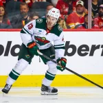 Oct 22, 2026; Calgary, Alberta, CAN; Minnesota Wild defenseman Quinn Hughes (43) controls the puck against the Calgary Flames during the third period at Scotiabank Saddledome.