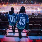 Oct 25, 2026; Vancouver, British Columbia, CAN; Fans wearing jerseys for Vancouver Canucks forward Elias Pettersson (40) and former Canuck and Minnesota Wild defenseman Quinn Hughes (43) arrive at the stadium in warm up prior to a game at Rogers Arena.