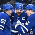 Jan 1, 2026; Toronto, Ontario, CAN; Toronto Maple Leafs forward Auston Matthews (34) celebrates with forwards Easton Cowan (53) and Nick Robertson (89) and defensemen Jake McCabe (22) and Troy Stecher (28) after scoring his third goal of the game against the Winnipeg Jets in the third period at Scotiabank Arena.