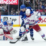 Oct 22, 2026; Toronto, Ontario, CAN; Toronto Maple Leafs center Jack Roslovic (96) battles for the puck with New York Rangers defenseman Braden Schneider (4) during the third period at Scotiabank Arena.