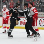 Nov 24, 2025; Newark, New Jersey, USA; New Jersey Devils center Nico Hischier (13) and Detroit Red Wings center Dylan Larkin (71) attempt to fight at the end of the third period at Prudential Center.
