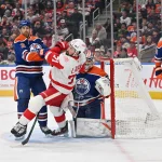 Dec 11, 2025; Edmonton, Alberta, CAN; Edmonton Oilers defenseman Evan Bouchard (2) collides with Detroit Red Wings center Dylan Larkin (71) in front of Edmonton Oilers goalie Stuart Skinner (74) during the second period at Rogers Place. Mandatory Credit: Walter Tychnowicz-Imagn Images