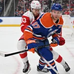 Dec 11, 2025; Edmonton, Alberta, CAN; Detroit Red Wings defenseman Moritz Seider (53) and Edmonton Oilers center Connor McDavid (97) chase the puck during the first period at Rogers Place.