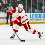 Oct 22, 2026; Vancouver, British Columbia, CAN; Detroit Red Wings forward Dylan Larkin (71) shoots against the Vancouver Canucks in the first period at Rogers Arena.