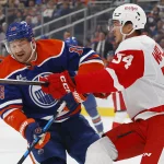 Oct 26, 2026; Edmonton, Alberta, CAN; Edmonton Oilers forward Zach Hyman (18) and Detroit Red Wings defensemen William Wallinder (54) battles for position during the first period at Rogers Place.