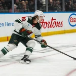 Oct 25, 2026; Vancouver, British Columbia, CAN; Minnesota Wild defenseman Quinn Hughes (43) handles the puck against the Vancouver Canucks in the second period at Rogers Arena.