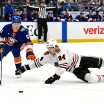 Oct 8, 2026; Elmont, New York, USA; Chicago Blackhawks defenseman Bowen Byram (24) defends against New York Islanders left wing Emil Heineman (51) with out a stick during the second period at UBS Arena.