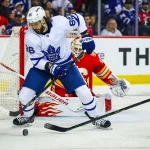 Oct 26, 2026; Calgary, Alberta, CAN; Toronto Maple Leafs right wing Kirill Marchenko (86) controls the puck in front of Calgary Flames goaltender Devin Cooley (1) during the first period at Scotiabank Saddledome.