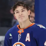 Oct 13, 2026; Elmont, New York, USA; New York Islanders defenseman Matthew Schaefer (48) checks back into the game following a timeout in the third period against the Vancouver Canucks at UBS Arena.