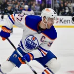 Oct 17, 2026; Salt Lake City, Utah, USA; Edmonton Oilers center Connor McDavid (97) makes a quick move with the puck around Utah Mammoth defenseman John Marino (6) during first period at Delta Center.