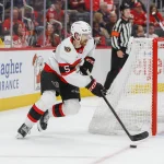 Oct 6, 2026; Detroit, Michigan, USA; Ottawa Senators defenseman Cameron Crotty (5) handles the puck during the second period against the Detroit Red Wings at Little Caesars Arena.