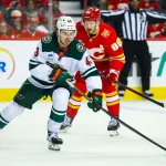 Oct 22, 2026; Calgary, Alberta, CAN; Minnesota Wild defenseman Quinn Hughes (43) controls the puck against the Calgary Flames during the third period at Scotiabank Saddledome.