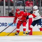 Apr 6, 2025; Detroit, Michigan, USA; Detroit Red Wings center Dylan Larkin (71) and Florida Panthers center Evan Rodrigues (17) battle for the puck during the first period at Little Caesars Arena.