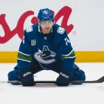 Oct 1, 2026; Vancouver, British Columbia, CAN; Vancouver Canucks forward Jake DeBrusk (74) stretches during warm up prior to a game against the Edmonton Oilers at Rogers Arena.