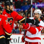 Oct 24, 2026; Calgary, Alberta, CAN; Detroit Red Wings center Dylan Larkin (71) and Calgary Flames right wing Adam Klapka (43) get into a scrum during the second period at Scotiabank Saddledome: