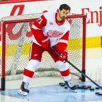 Oct 24, 2026; Calgary, Alberta, CAN; Detroit Red Wings center Dylan Larkin (71) controls the pucks during the warmup period against the Calgary Flames at Scotiabank Saddledome.